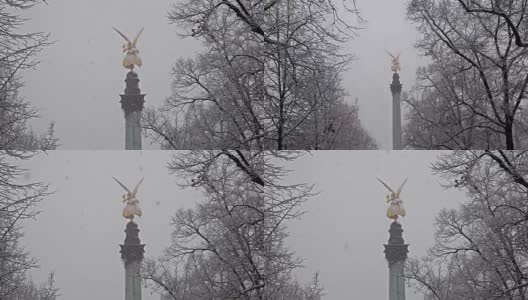 在暴风雪中，德国慕尼黑弗里登森格尔纪念碑顶端的和平天使高清在线视频素材下载