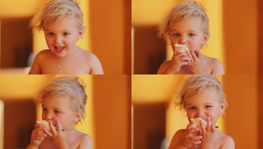 可爱可爱的小男孩开心的张大嘴巴。幼儿咬梨吃健康的水果高清在线视频素材下载