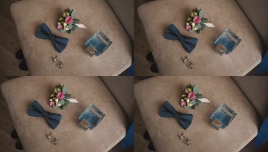 优雅的男士婚礼配件，马桶水带扣孔躺在椅子上，他的夹克挂在椅背上5高清在线视频素材下载