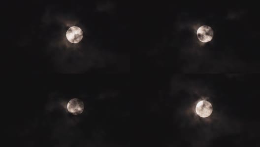 特写满月在黑暗的夜晚与云移动它。Motion 4k b-roll footage高清在线视频素材下载