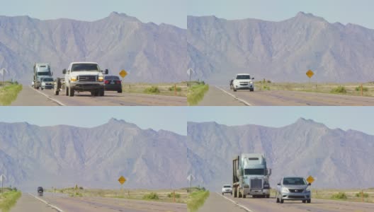 在一个阳光明媚的日子里，汽车、卡车、半挂卡车和其他车辆沿着一条以山为背景的高速公路行驶高清在线视频素材下载