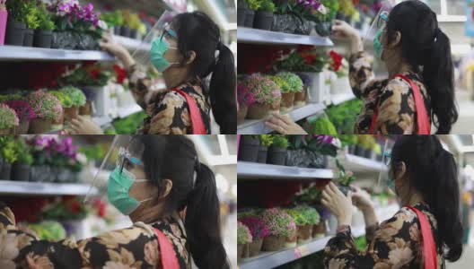 亚洲年轻女子戴着口罩在超市购物高清在线视频素材下载