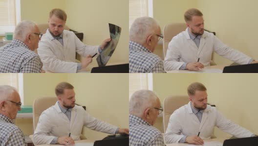 一位男性神经学家正在和一位老年病人一起看x光片高清在线视频素材下载