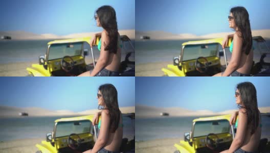 年轻女子坐在马车里，在杰里科阿拉的沙丘上看风景高清在线视频素材下载