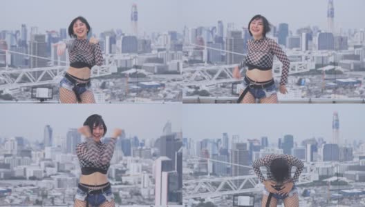 亚洲年轻女子与烟雾弹在屋顶塔跳舞高清在线视频素材下载