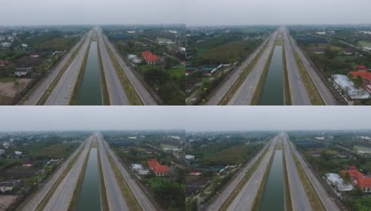 运河沿线空空如也的高速公路的鸟瞰图和旁边的住宅区高清在线视频素材下载