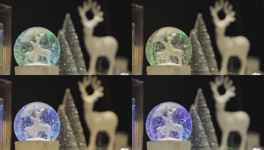 雪球上有鹿的身影，鹿的身影和松树，鹿的身影在球上闪烁高清在线视频素材下载