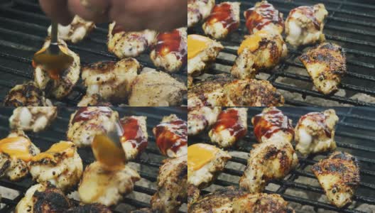一个高加索人在一个户外烧烤架上用勺子把水牛城/辣酱浇在烹饪鸡翅上高清在线视频素材下载