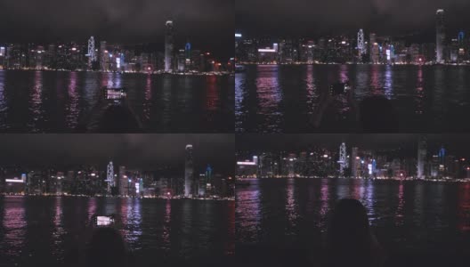 旅行者们用手机拍摄香港的夜景。高清在线视频素材下载