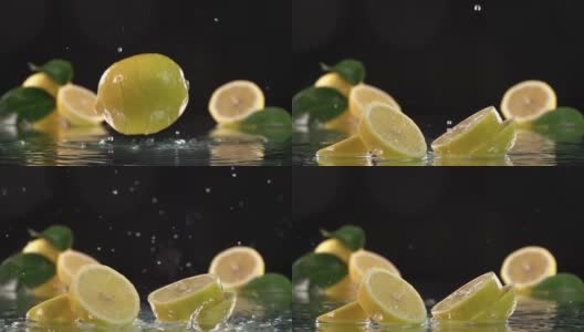 柠檬碰到橙汁表面，然后切成两半。慢动作镜头高清在线视频素材下载