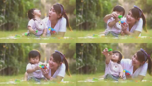 亚洲母亲和婴儿有乐趣户外。一起在绿夏公园。妈妈和孩子。幸福的家庭微笑。美丽的家庭在春天的公园享受大自然。高清在线视频素材下载