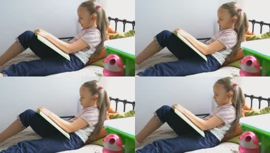 小女生在床上看书。高清在线视频素材下载