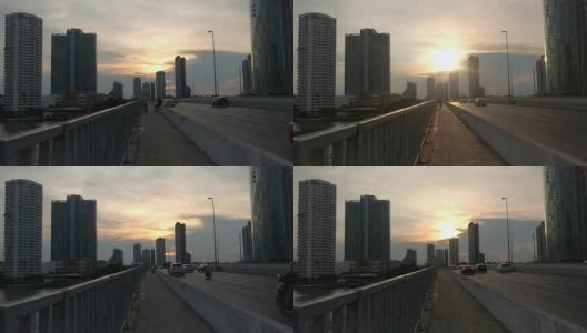 时间流逝的观点，现代建筑背景城市曼谷在傍晚日落。旅行的人在路上。高清在线视频素材下载