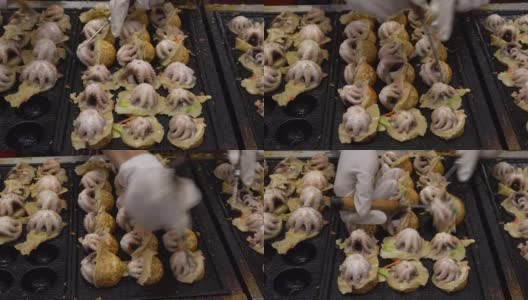 烹饪球形街头小吃饺子与大鱿鱼油炸小吃在日本。高清在线视频素材下载