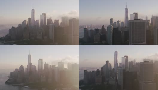 在低空云层和清晨阳光下的曼哈顿建筑中追踪。高清在线视频素材下载