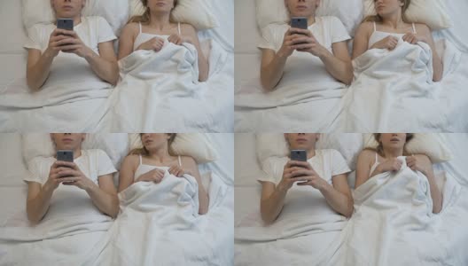 男朋友在床上玩手机游戏，无视女朋友，夫妻问题高清在线视频素材下载