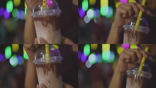 女子用吸管喝冰牛奶巧克力高清在线视频素材下载