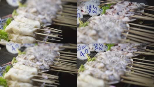 特写生鱿鱼串烤鱿鱼摊上的菜-泰国街头食品高清在线视频素材下载