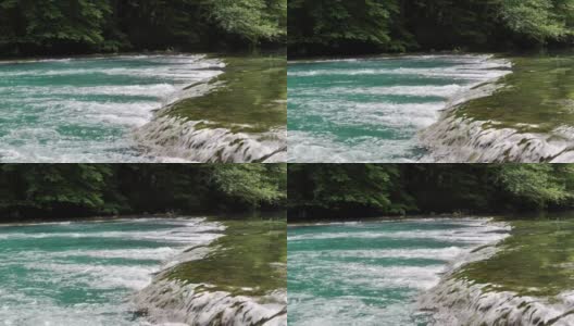 门限位于一条小山河上，有碧蓝的水在石头之间流动。高清在线视频素材下载