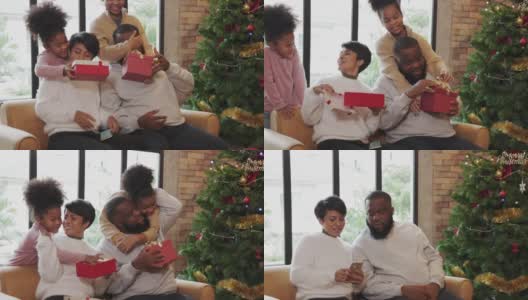 两个孩子在圣诞节那天用一个礼品盒给爸爸妈妈一个惊喜。高清在线视频素材下载