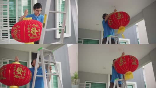 亚洲华人男子挂红灯笼在他家的前院在中国新年前夕高清在线视频素材下载