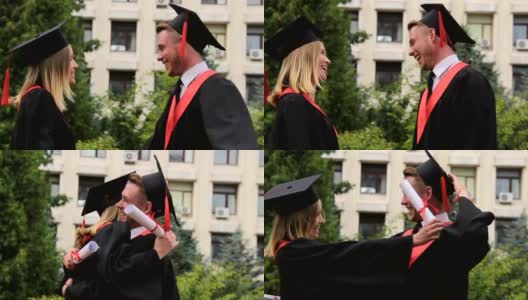 毕业典礼上，最好的朋友们穿着学位服，戴着学位帽，拥抱着，微笑着高清在线视频素材下载