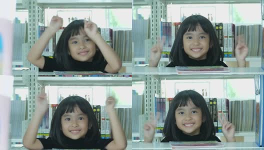 图书馆里亚洲女孩的胜利手势高清在线视频素材下载