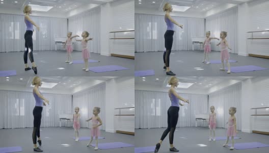 儿童舞蹈学校的老师在演播室展示女孩们的练习高清在线视频素材下载