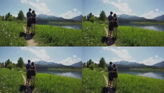 一对夫妇手挽着手站在一起观看美丽的山脉4k高清在线视频素材下载