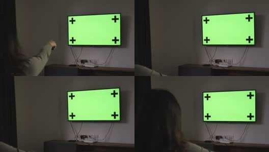 看电视的女人在晚上的绿色屏幕高清在线视频素材下载
