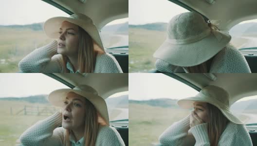 一个戴着帽子的女人坐在汽车后座上，看到了一些可怕的东西高清在线视频素材下载