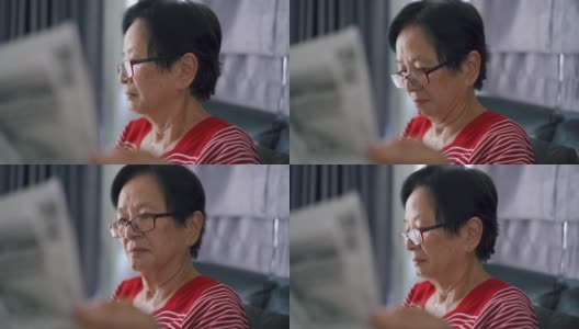 老妇人在看晨报。高清在线视频素材下载
