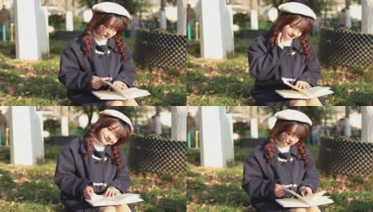 秋天，日落时分，一个女人在外面看书。高清在线视频素材下载