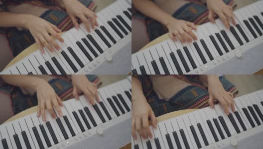 在家独自键盘钢琴爱好年轻女子练习钢琴。高清在线视频素材下载