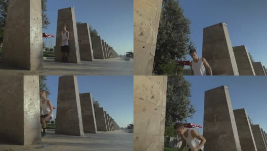 一个年轻人在城里玩翻滚戏法高清在线视频素材下载