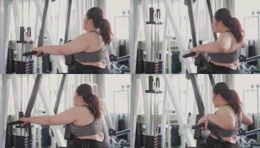 超重妇女在健身房里使用运动器材减肥。高清在线视频素材下载