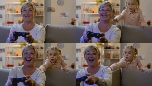 孙女发现奶奶在玩电子游戏，很惊讶，还跟那个女人开玩笑高清在线视频素材下载