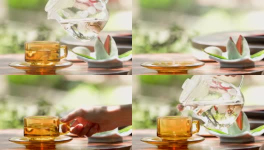 4K倾倒樱花花茶在日本花园的背景高清在线视频素材下载