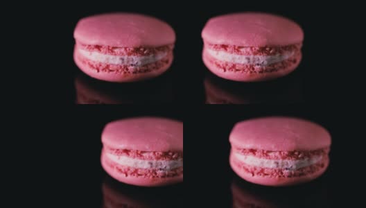 粉色法式马卡龙，黑色背景。美味的传统法国甜点近距离高清在线视频素材下载