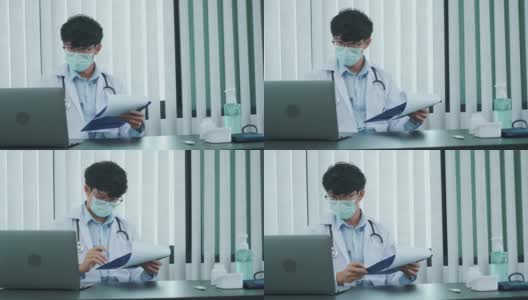 一位亚洲医生正在用笔记本电脑工作，在办公室里写病人的病史。高清在线视频素材下载