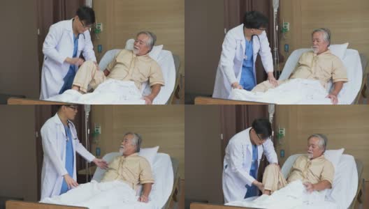 一位年轻的亚洲医生在医院医务室的病床上检查这位老人手术后的膝盖和腿。高清在线视频素材下载