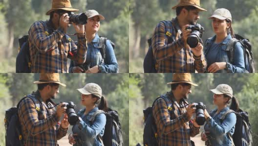 一对夫妇在森林里浏览相机照片高清在线视频素材下载