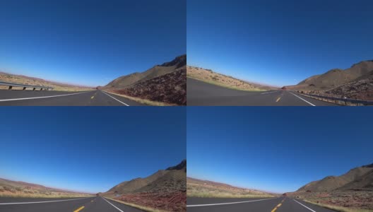 美国的公路雄伟壮观，无穷无尽，是公路旅行的理想之地。这条路在火红的群山、丘陵和广阔的沙漠中蜿蜒曲折。具有完美路面和标记的道路高清在线视频素材下载