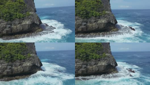 蓝绿色的海浪撞击着岩石，努沙佩尼达巴厘岛高清在线视频素材下载