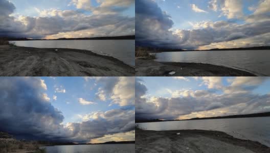 漫步在沙质的湖岸，在壮观的天空下高清在线视频素材下载