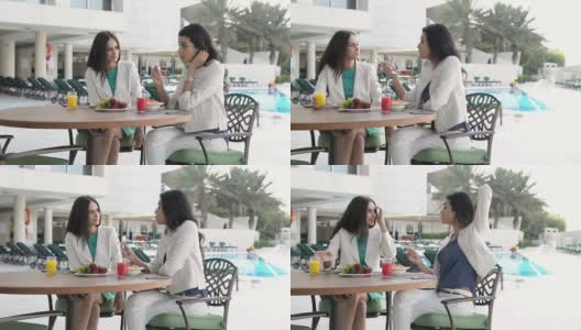 PANNING:酒店泳池咖啡厅里的职业年轻女性高清在线视频素材下载