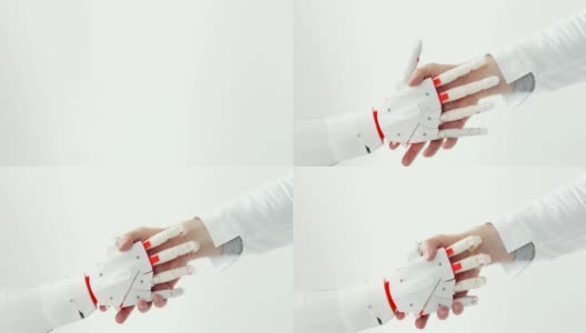 白大褂的人手与白色背景下的机器人假肢手的握手高清在线视频素材下载
