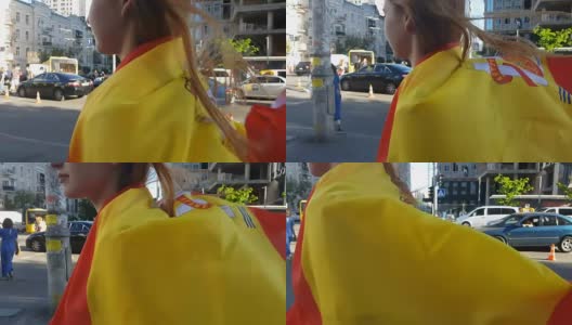 美丽的女孩包裹在西班牙国旗走过城市，拉拉队的特写镜头高清在线视频素材下载