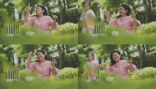 泰国美丽的高级女教师是跳舞和教她的侄女与有趣和放松的花园高清在线视频素材下载