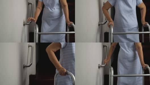 老妇人扶着扶手安全行走高清在线视频素材下载